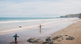 Thumbnail of man walking into the sea with a surfboard